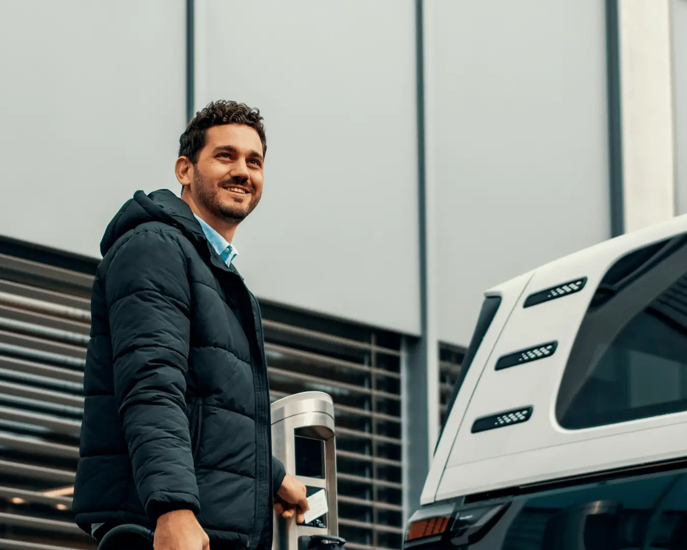 Man charging an electric vehicle