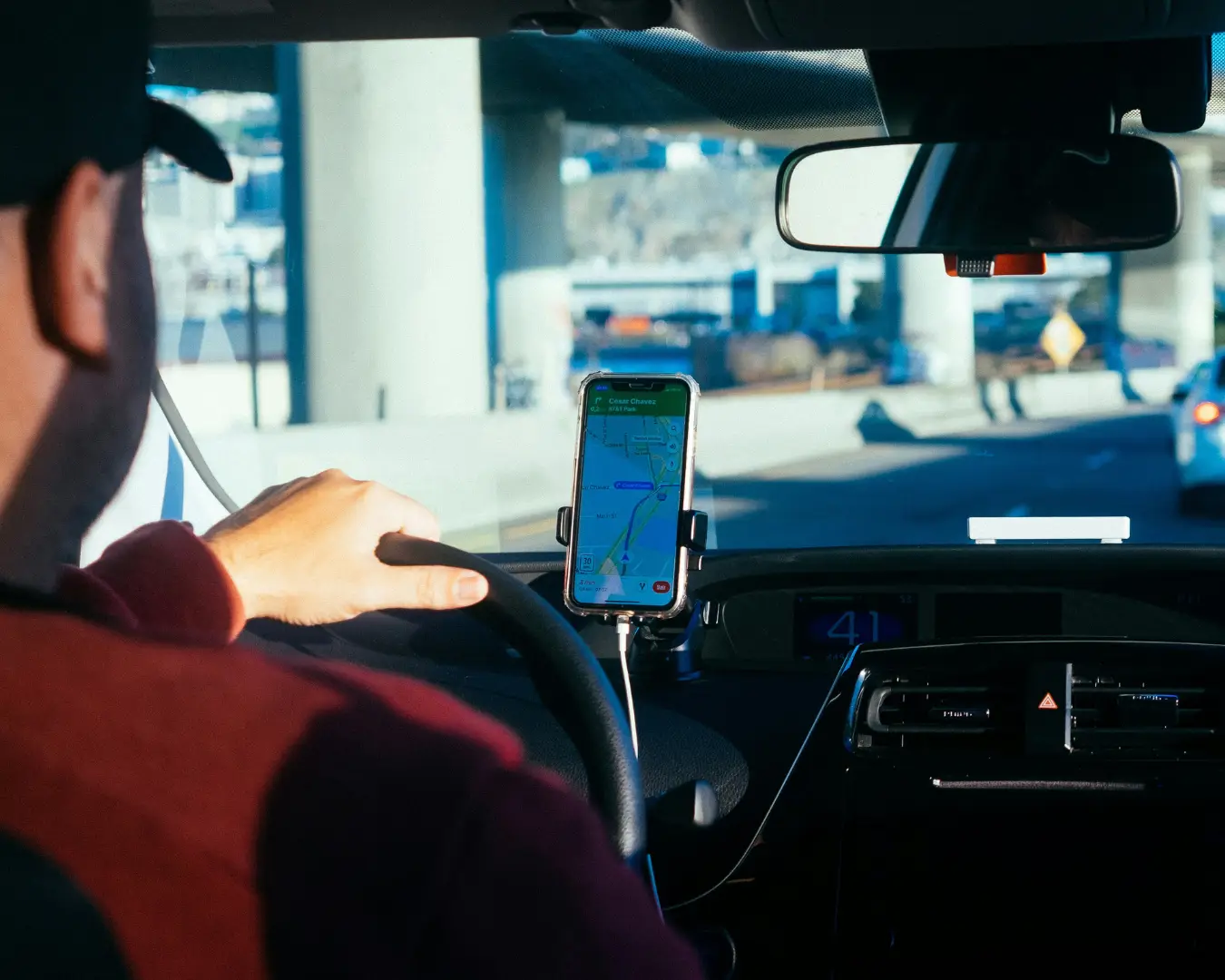 Rideshare driver looking at a map on his phone