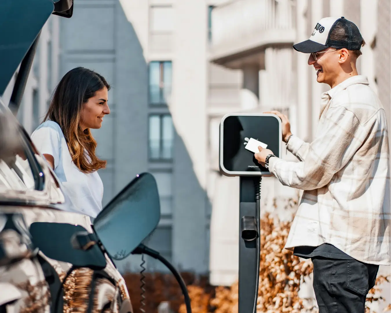Man and woman charging an electric vehicle